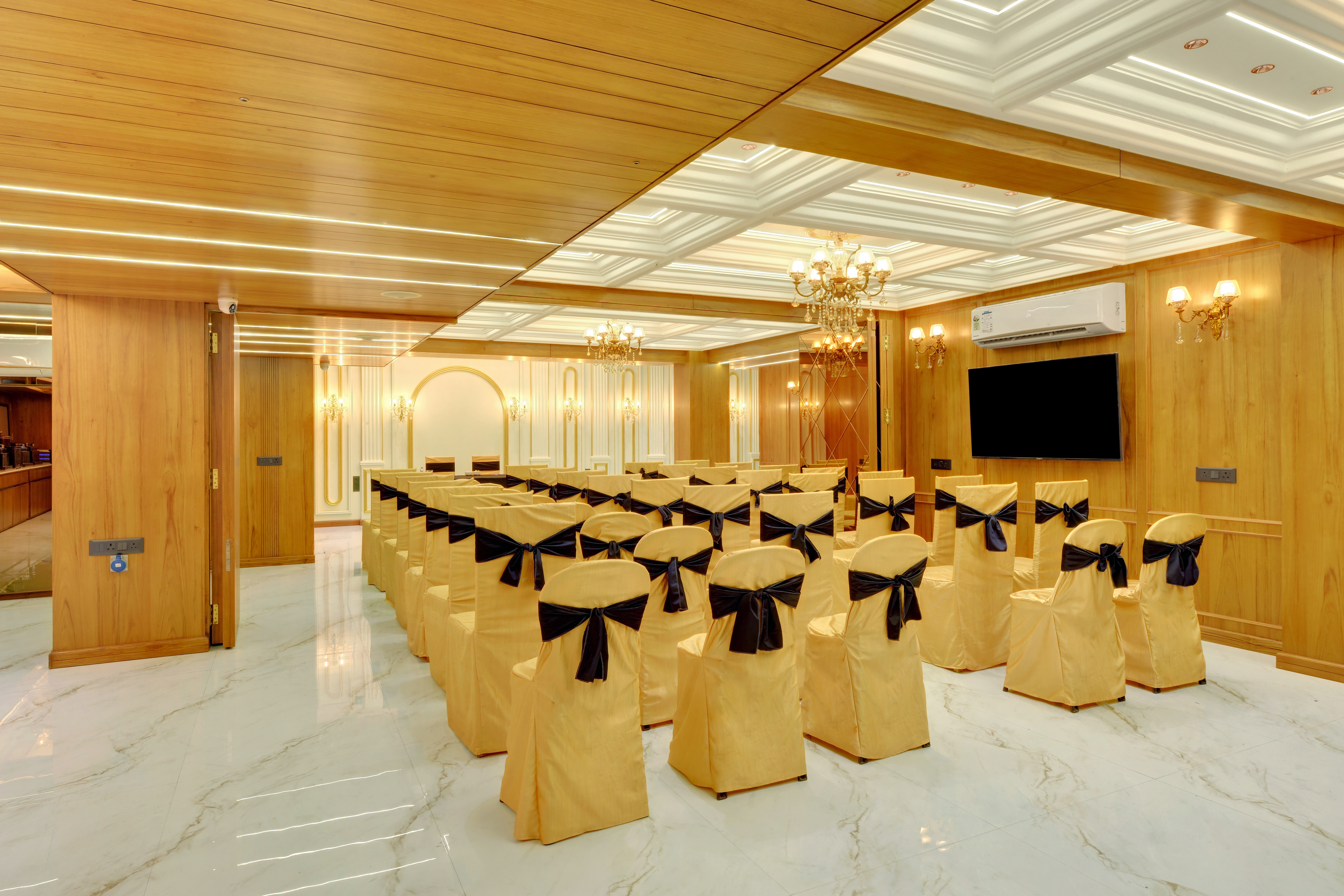 Conference seating arrangement at Hotel Shital Inn with a wall-mounted display